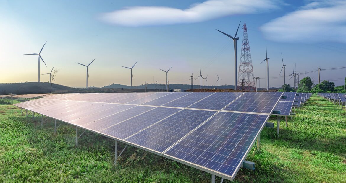 renewable-energy-solar-panels-wind-turbines-green-grass-blue-sky renewable-energy-solar-panels-wind-turbines-green-grass-blue-sky